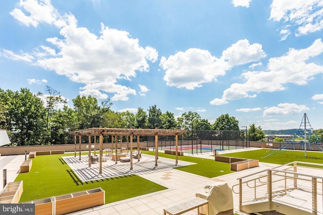 view of property's community featuring fence and a pergola