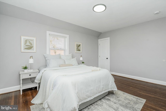 bedroom featuring vaulted ceiling and dark hardwood / wood-style floors