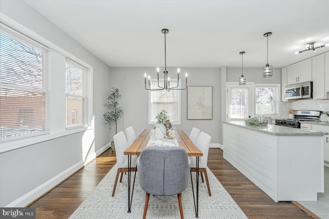 dining room featuring dark hardwood / wood-style flooring and a chandelier