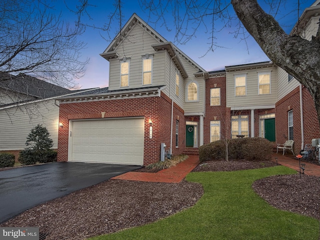 view of front of house with driveway and brick siding