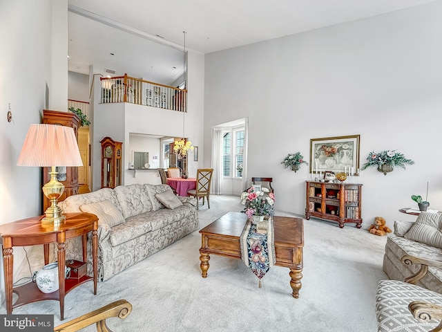 carpeted living room with a high ceiling