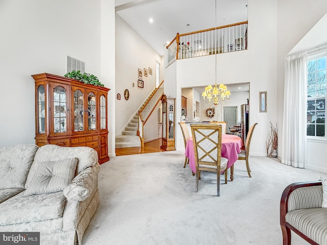 dining space with baseboards, light carpet, an inviting chandelier, and stairs