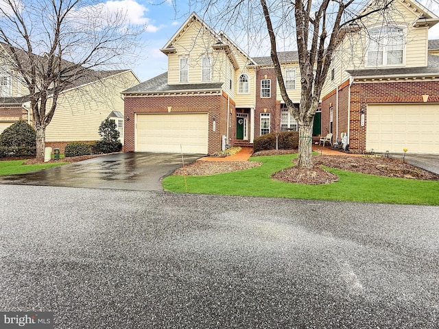 traditional-style house with aphalt driveway and brick siding