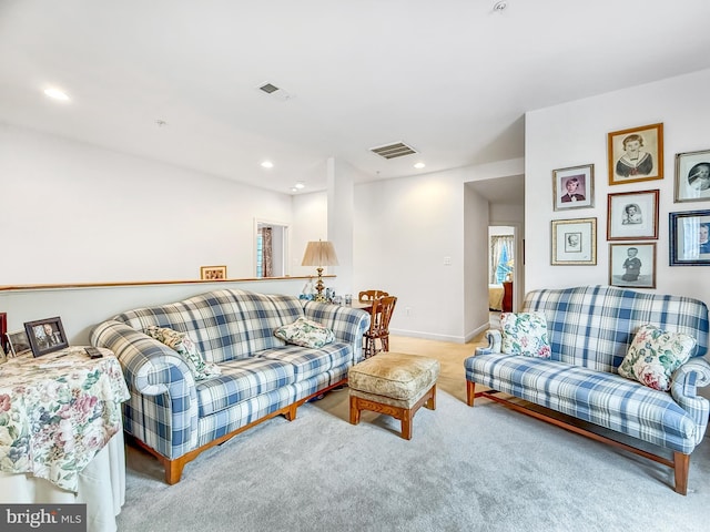 living room featuring light carpet, baseboards, visible vents, and recessed lighting