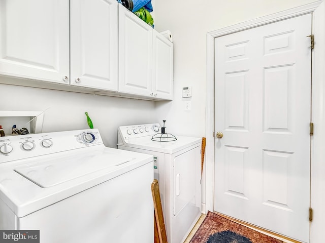 laundry area with cabinet space and separate washer and dryer