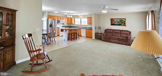 living room featuring ceiling fan and baseboards