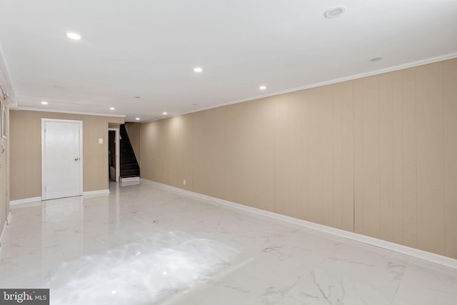 below grade area with stairs, crown molding, recessed lighting, and marble finish floor