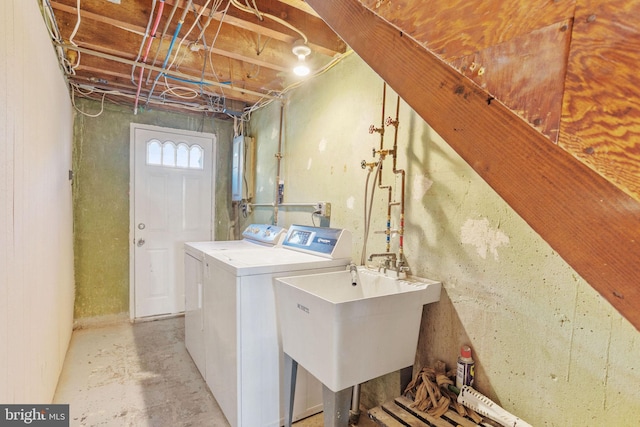 washroom featuring a sink, independent washer and dryer, and laundry area