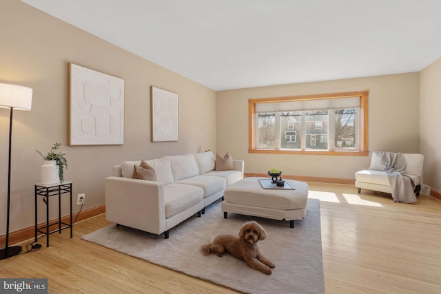 living room featuring baseboards and wood finished floors