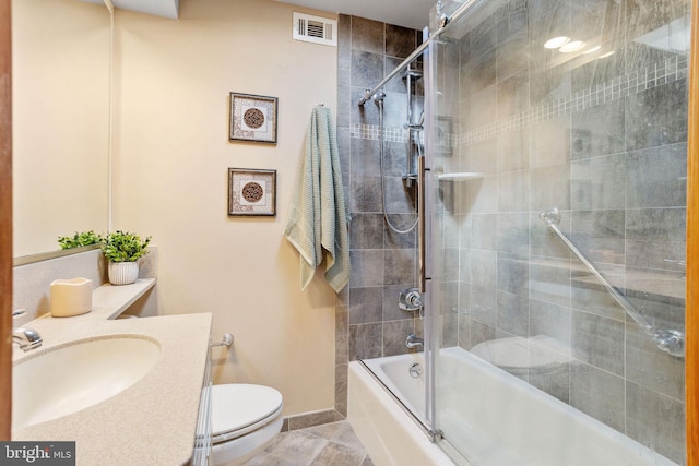 full bath featuring vanity, baseboards, visible vents, enclosed tub / shower combo, and toilet