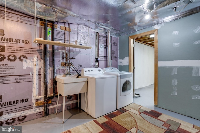 clothes washing area with washer and dryer