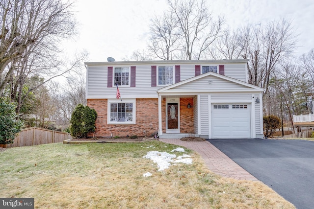 view of property featuring a front yard and a garage