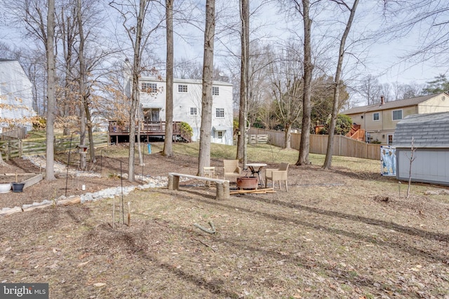 view of yard with a shed and a wooden deck