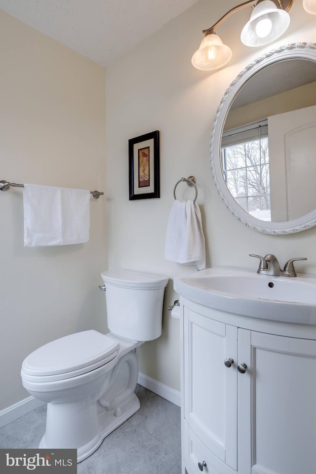 bathroom with vanity, tile patterned flooring, and toilet