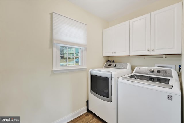 laundry area featuring wood-type flooring, cabinets, and washer and clothes dryer