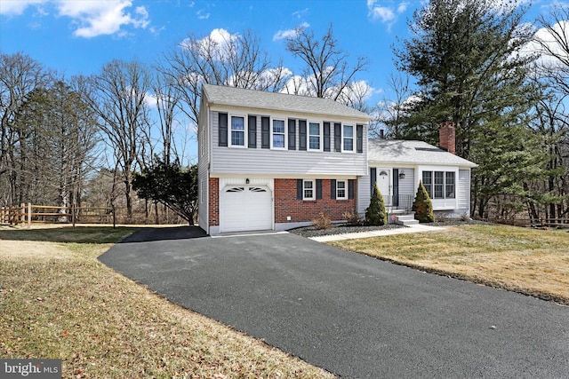 view of front of home featuring a garage and a front lawn