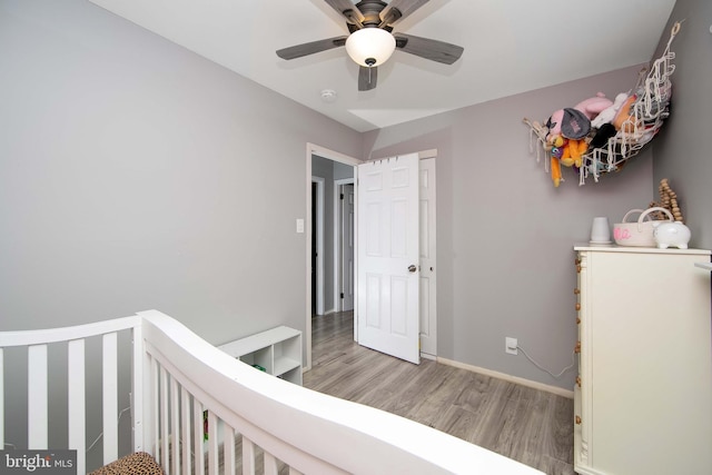 bedroom with baseboards, ceiling fan, and light wood finished floors