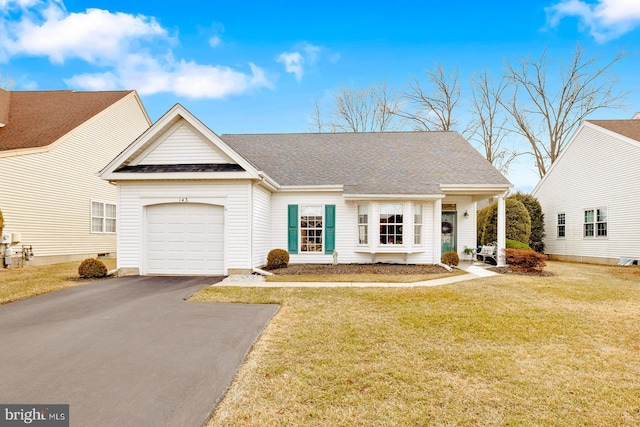 view of front of home featuring a front lawn, a shingled roof, aphalt driveway, and an attached garage