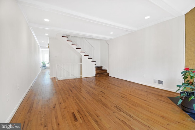 unfurnished living room with hardwood / wood-style floors and beam ceiling