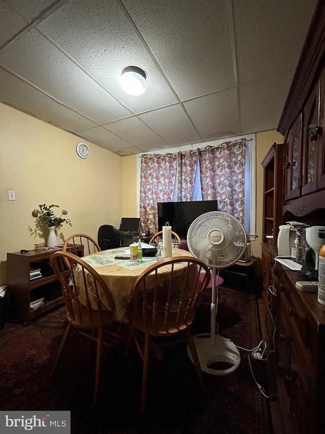 dining space with a paneled ceiling