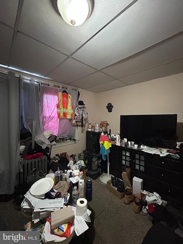 bedroom featuring carpet flooring and a drop ceiling