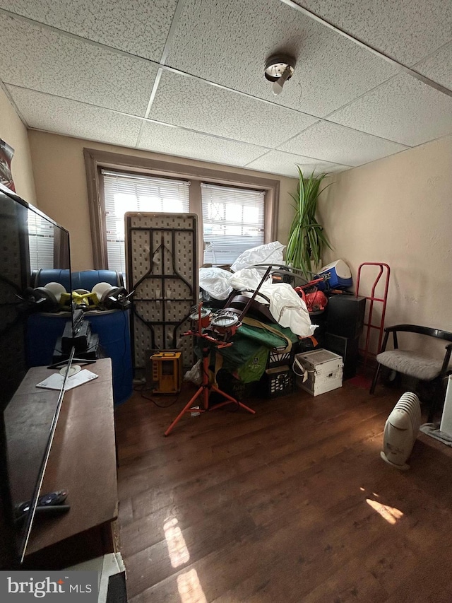 miscellaneous room with a paneled ceiling and wood finished floors