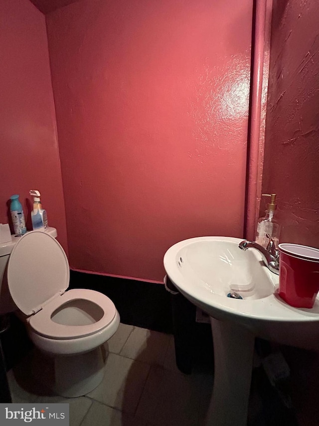 bathroom featuring tile patterned floors and toilet