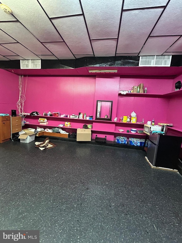 interior space with visible vents and a paneled ceiling