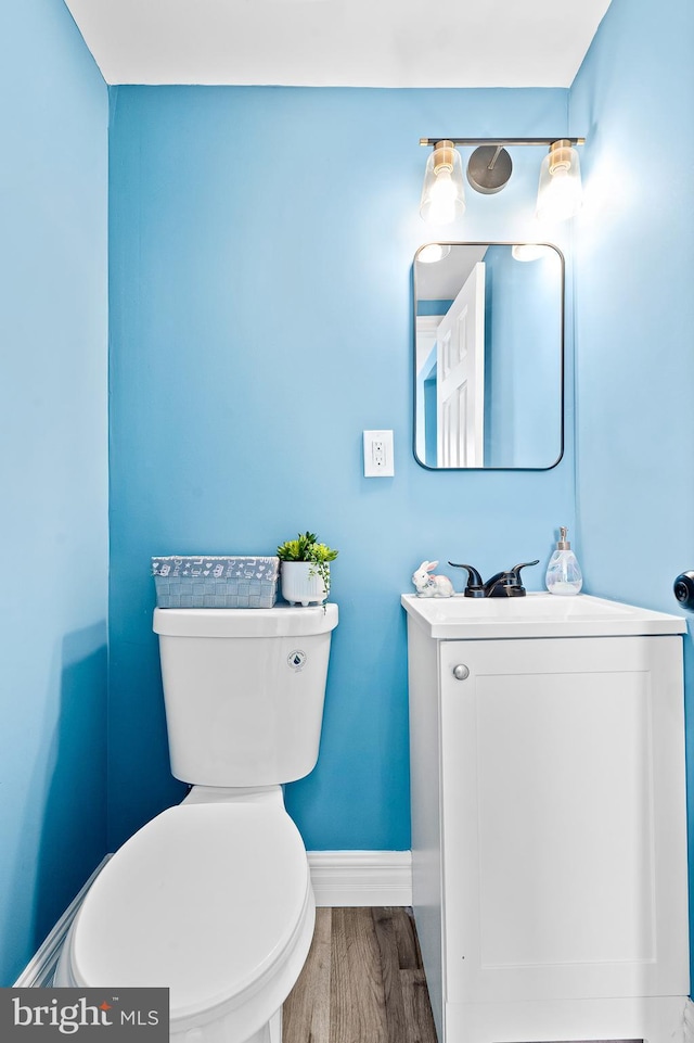 bathroom featuring hardwood / wood-style flooring, vanity, and toilet