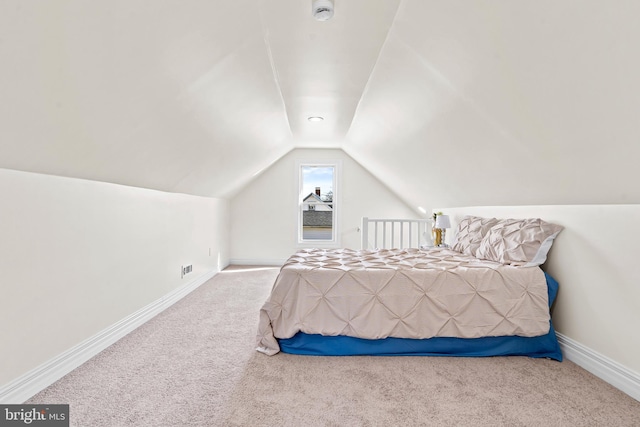 carpeted bedroom featuring vaulted ceiling