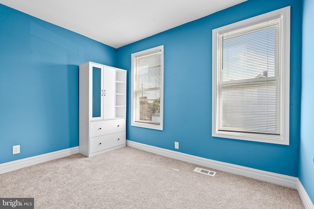 unfurnished bedroom with light colored carpet