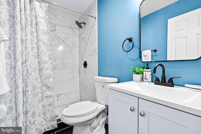 bathroom with walk in shower, vanity, and toilet