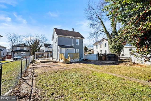 rear view of house featuring a lawn