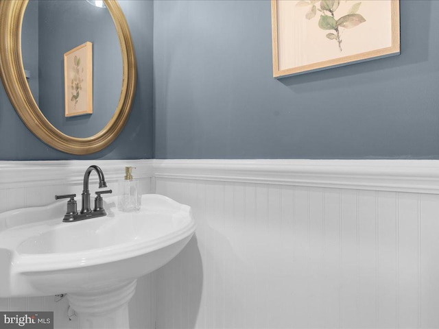 bathroom with a sink and wainscoting