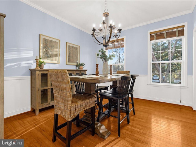 dining room featuring wood-type flooring and ornamental molding