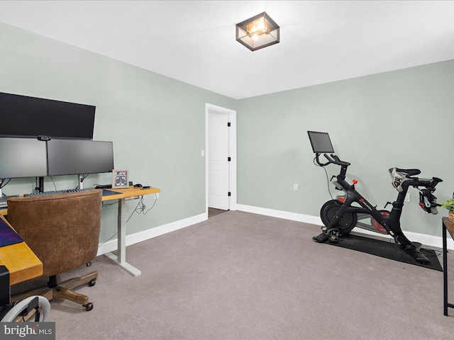 carpeted home office featuring baseboards