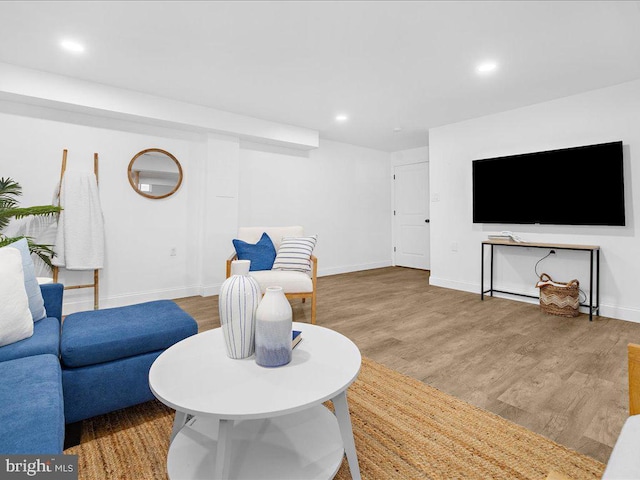 living room with recessed lighting, baseboards, and wood finished floors