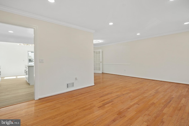 unfurnished room featuring recessed lighting, visible vents, baseboards, ornamental molding, and light wood finished floors