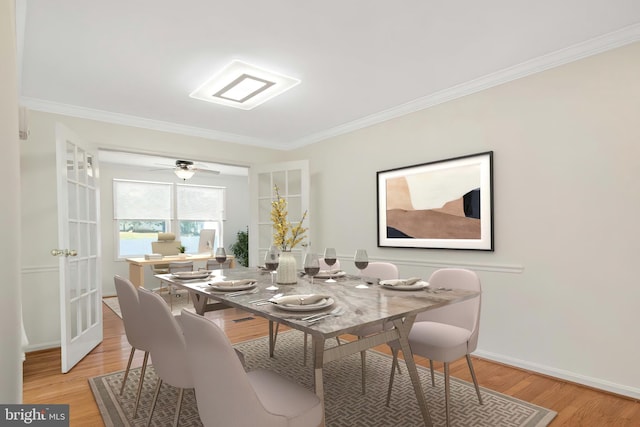 dining space with crown molding, baseboards, and light wood-style floors