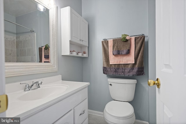 full bathroom featuring baseboards, vanity, and toilet