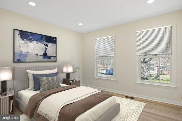 bedroom featuring recessed lighting, visible vents, baseboards, and wood finished floors