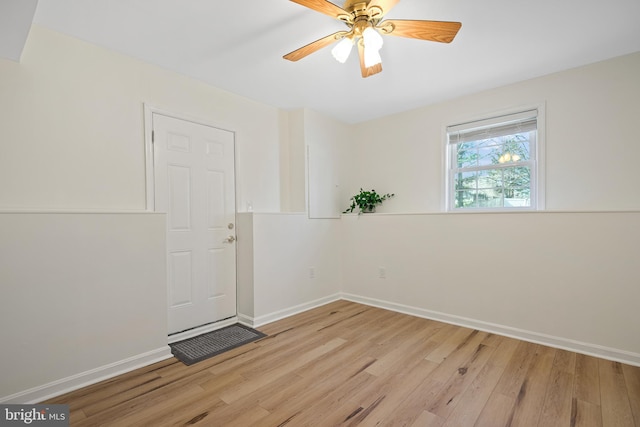 unfurnished room featuring light wood-style floors, baseboards, and a ceiling fan