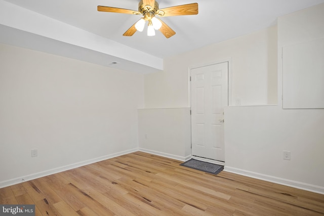 empty room with light wood-type flooring, baseboards, and a ceiling fan