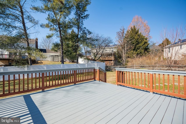 deck with a lawn and a fenced backyard