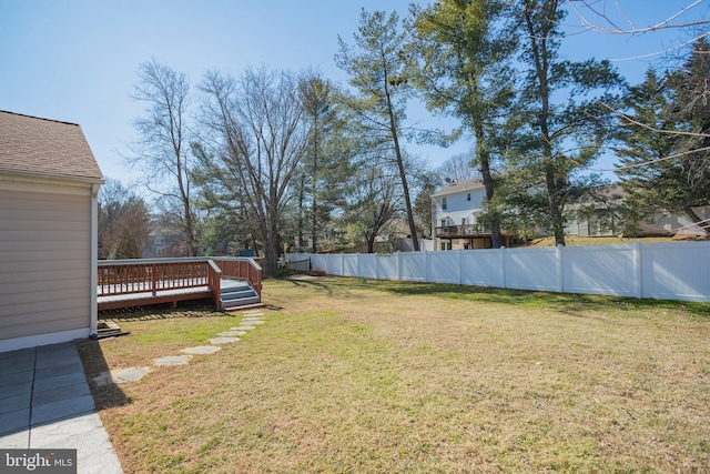 view of yard with fence and a deck