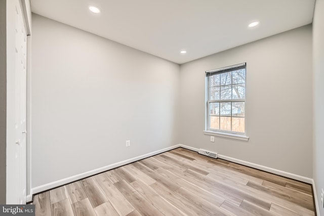 unfurnished room with light wood-type flooring