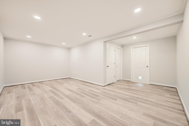 basement with light hardwood / wood-style floors