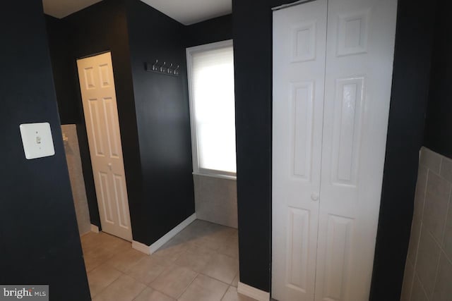 hallway featuring light tile patterned floors