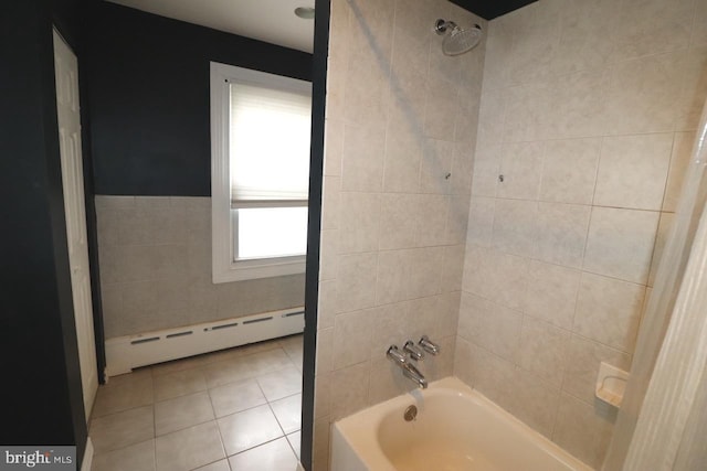 bathroom featuring tiled shower / bath combo, tile patterned flooring, baseboard heating, and tile walls