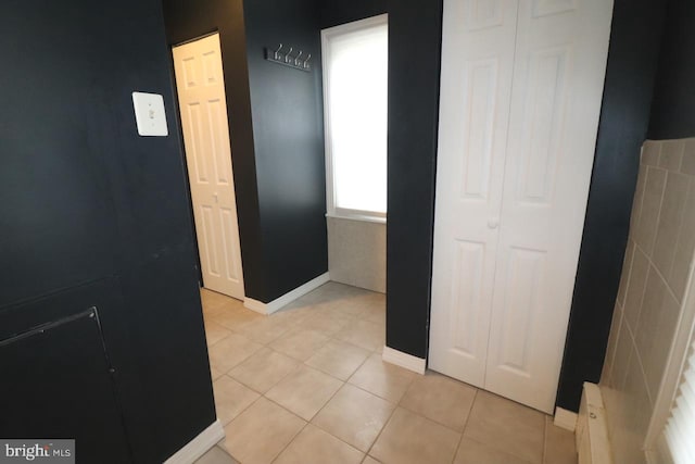 hall featuring light tile patterned floors